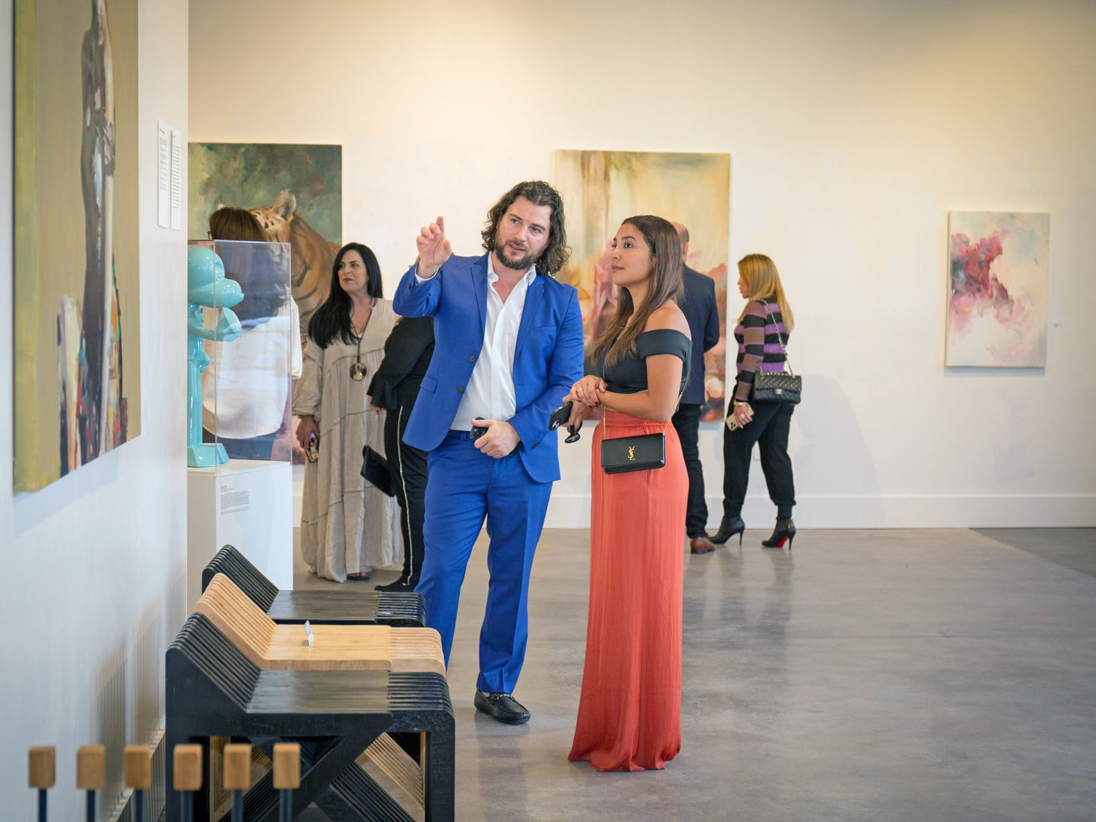 Upcoming dates of the European tour 4 Artist Alex Righetto showing a painting titled 'Mona Lisa's Daughter' to an art collector in a gallery setting