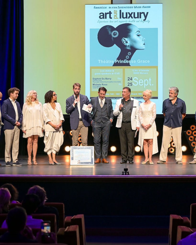 Alex Righetto on stage at Art & Luxury Monaco 2026 with Princess Margherita de Bourbon de Parme and event organizer Annette at the Théâtre Princesse Grace.
